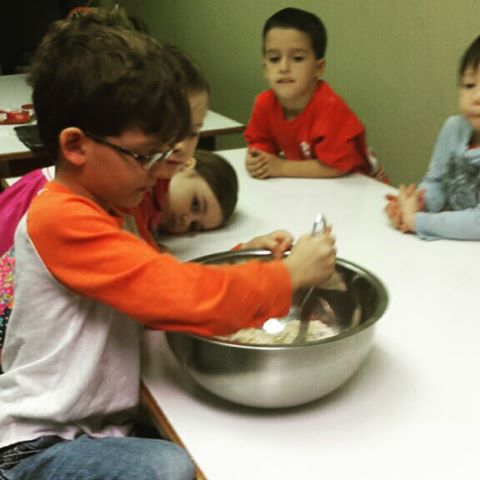 sweet little preschool friends making cookies